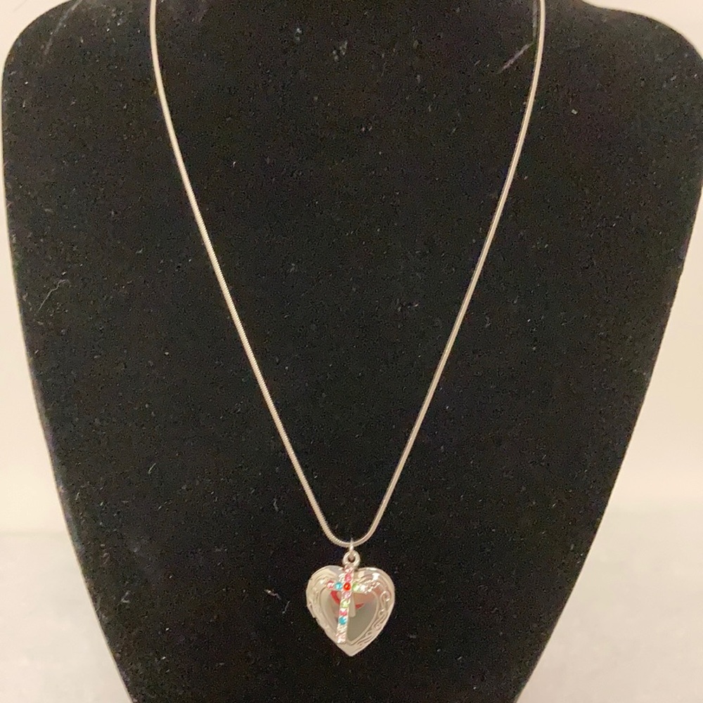 Silver locket with multi colored cross